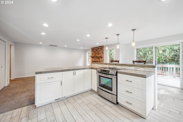 kitchen featuring light hardwood / wood-style flooring, electric stove, hanging light fixtures, and white cabinetry