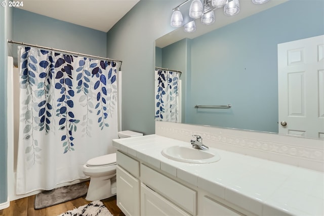 bathroom featuring vanity, hardwood / wood-style flooring, and toilet