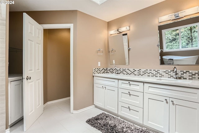 bathroom featuring tile patterned floors, decorative backsplash, and double vanity