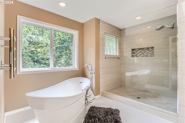 bathroom featuring tile patterned floors, separate shower and tub, and plenty of natural light