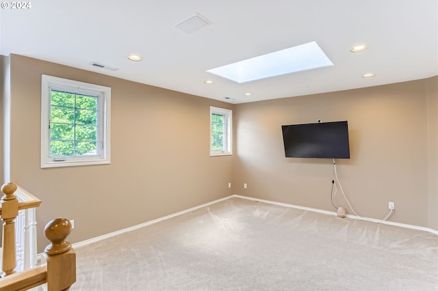 carpeted spare room with a skylight