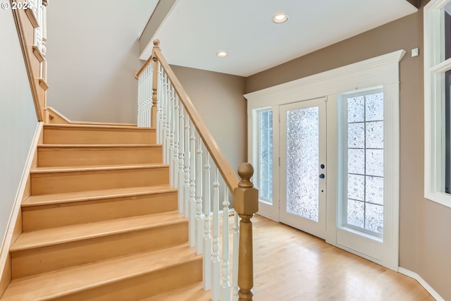 entryway with light hardwood / wood-style flooring, a wealth of natural light, and french doors