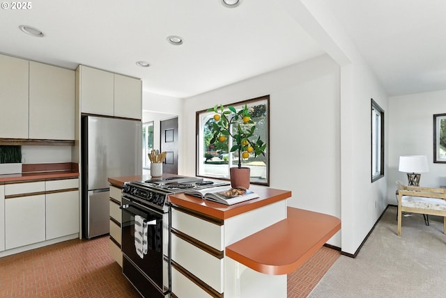 160 Beatrice Ave, Gladstone, OR 97027 - kitchen with black electric range oven, freestanding refrigerator, light colored carpet, recessed lighting, and dark countertops