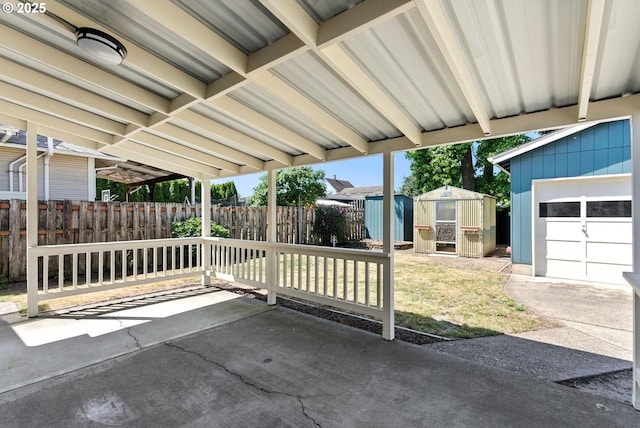 160 Beatrice Ave, Gladstone, OR 97027 - view of patio with a storage unit and a garage