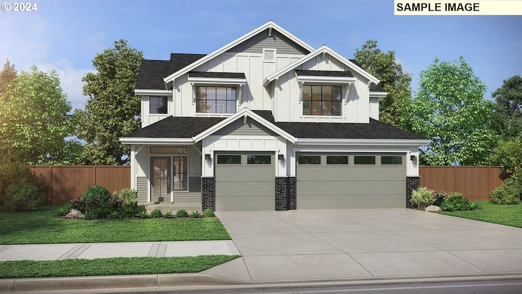 view of front of house featuring a front yard and a garage