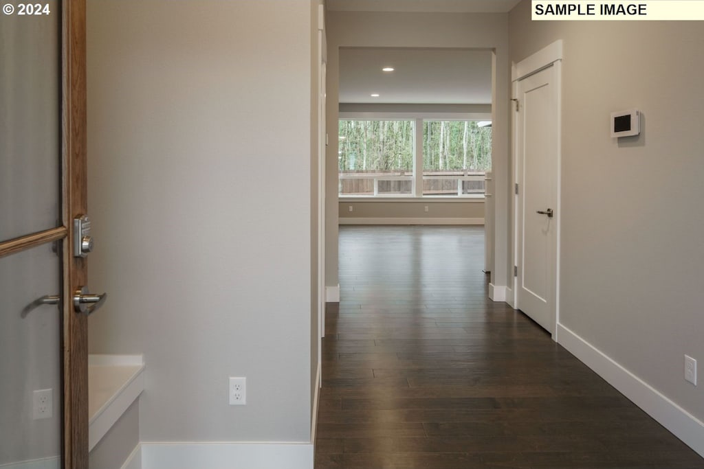 corridor featuring dark wood-type flooring