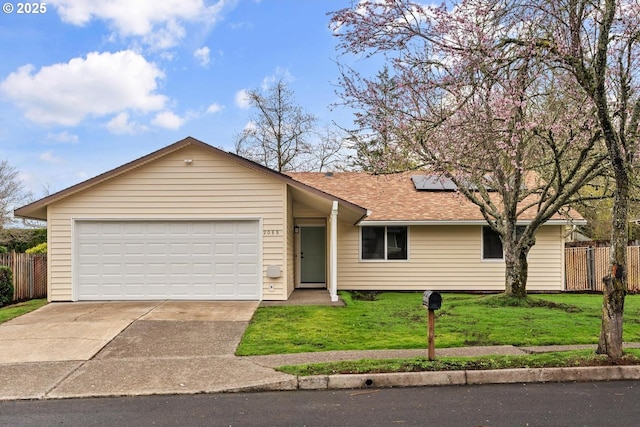 ranch-style home featuring a garage, a front lawn, and fence