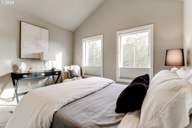 bedroom featuring high vaulted ceiling and carpet flooring