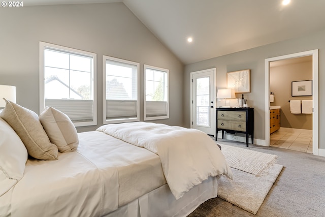 carpeted bedroom featuring lofted ceiling and connected bathroom