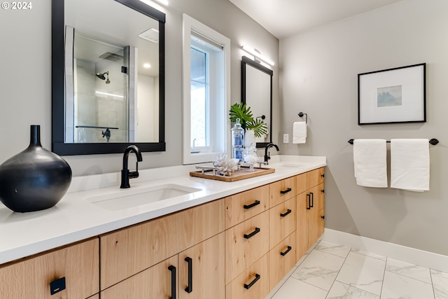 bathroom with vanity and a shower with shower door