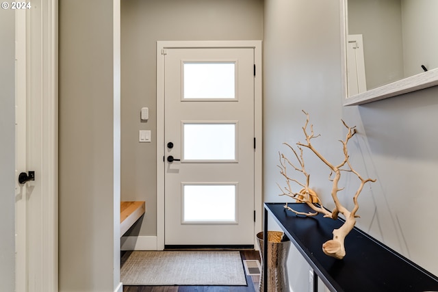 doorway with a healthy amount of sunlight and hardwood / wood-style flooring