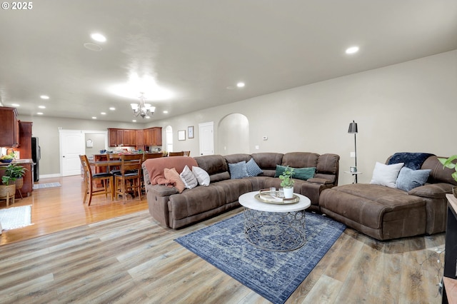 living room featuring an inviting chandelier and light hardwood / wood-style floors