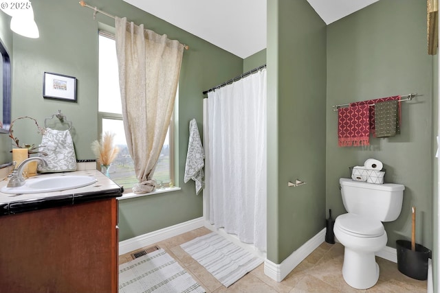 bathroom featuring vanity, toilet, and tile patterned flooring