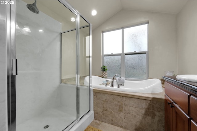 bathroom featuring vaulted ceiling, shower with separate bathtub, and vanity