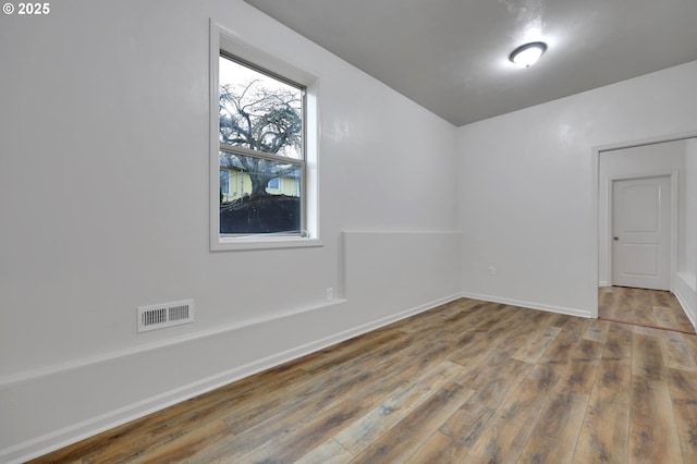 unfurnished room featuring hardwood / wood-style floors