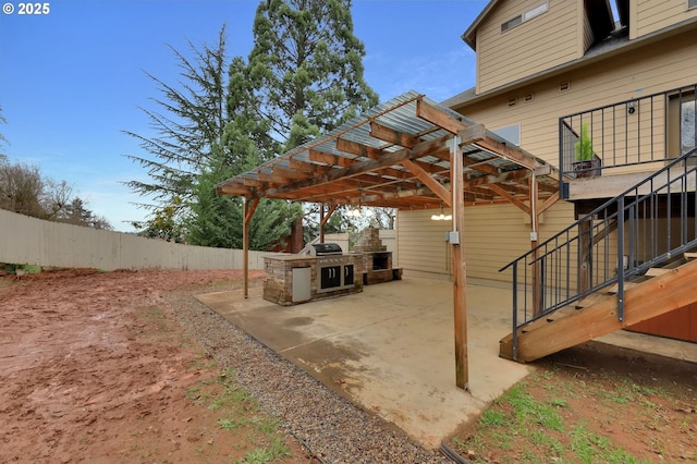 view of patio / terrace featuring an outdoor kitchen and a grill