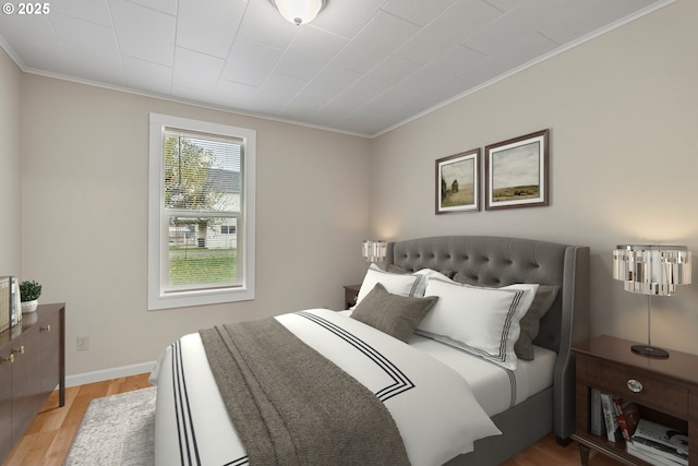 bedroom featuring light hardwood / wood-style flooring and ornamental molding