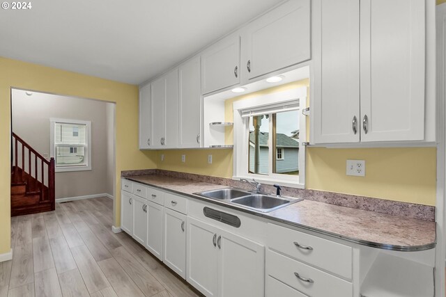 kitchen featuring white cabinetry and sink