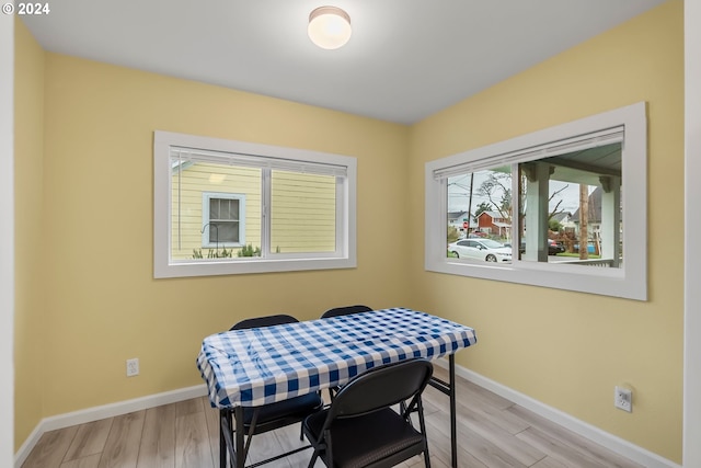 dining space with light hardwood / wood-style floors