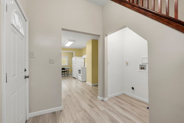 laundry room featuring washer hookup, light hardwood / wood-style floors, and a healthy amount of sunlight