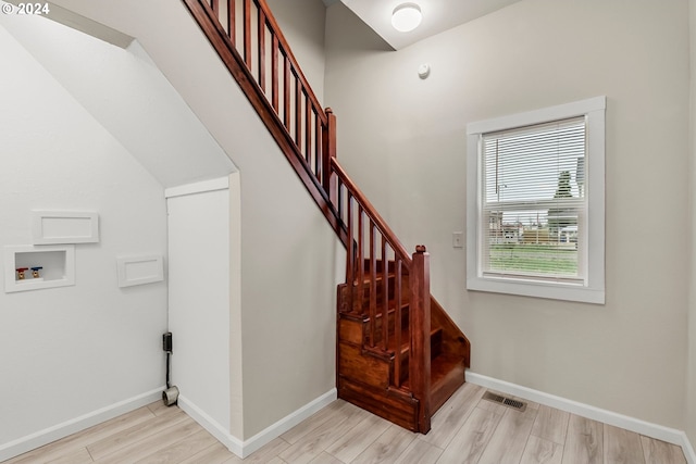 staircase with hardwood / wood-style floors