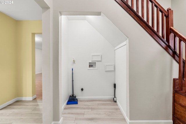 washroom featuring hookup for a washing machine and light hardwood / wood-style flooring