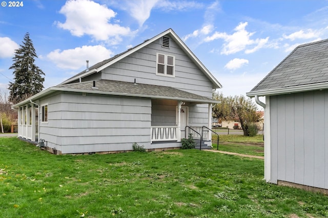 rear view of property with a yard