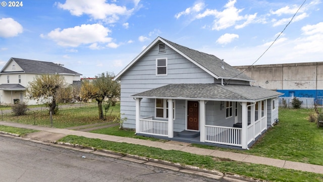 bungalow-style home featuring a porch and a front yard