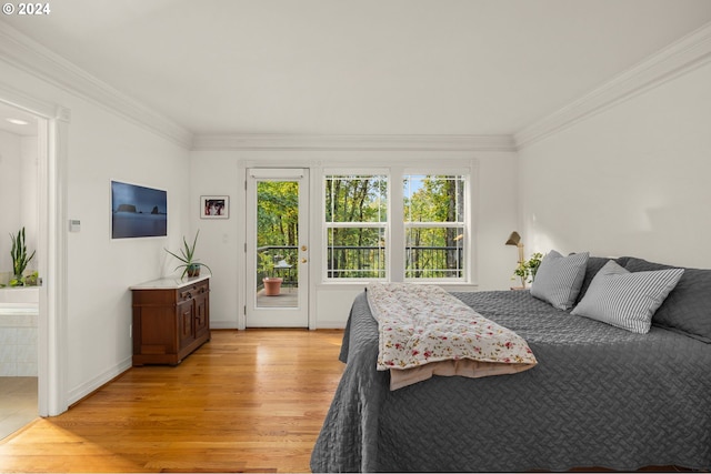 bedroom featuring access to exterior, light hardwood / wood-style floors, and ornamental molding