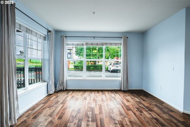 unfurnished room featuring hardwood / wood-style floors