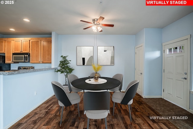 dining space featuring dark hardwood / wood-style floors and ceiling fan