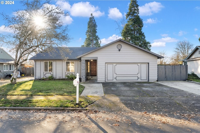 ranch-style home featuring a garage and a front yard