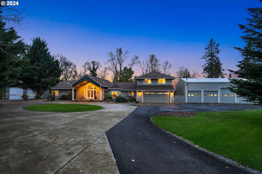 view of front of home with a yard and a garage