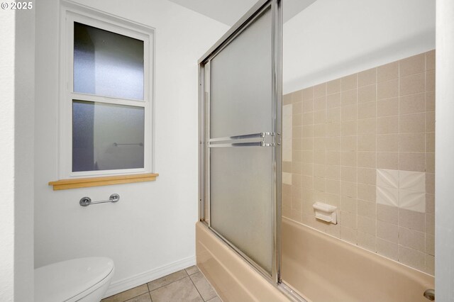 bathroom with toilet, combined bath / shower with glass door, and tile patterned flooring