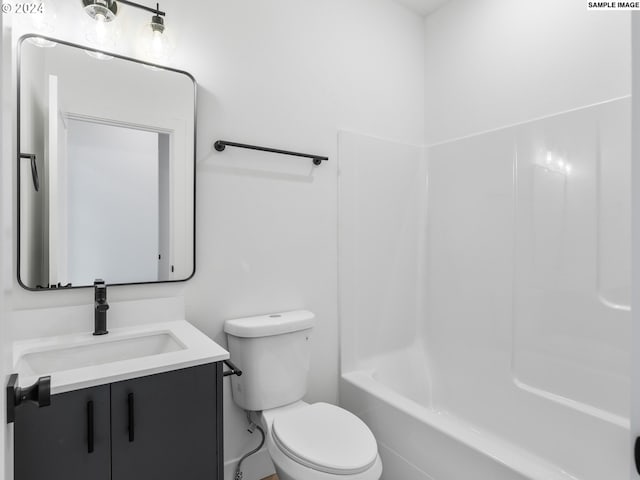 full bathroom with bathtub / shower combination, vanity, and toilet