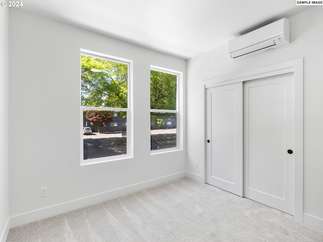 unfurnished bedroom featuring light colored carpet, a closet, and a wall mounted air conditioner