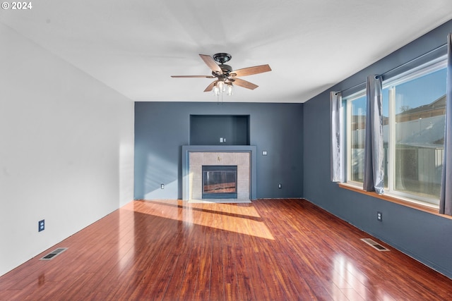 unfurnished living room featuring ceiling fan, a fireplace, and hardwood / wood-style flooring