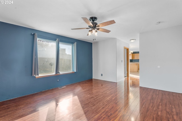 unfurnished room with ceiling fan and dark hardwood / wood-style flooring