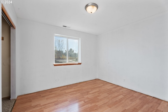 unfurnished bedroom with a closet and light hardwood / wood-style floors