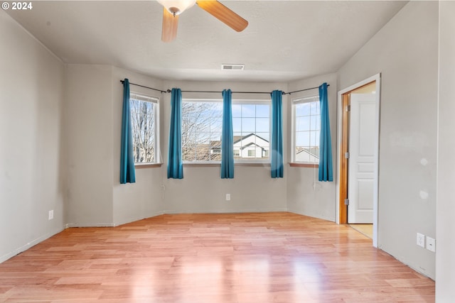 spare room featuring ceiling fan and light hardwood / wood-style floors