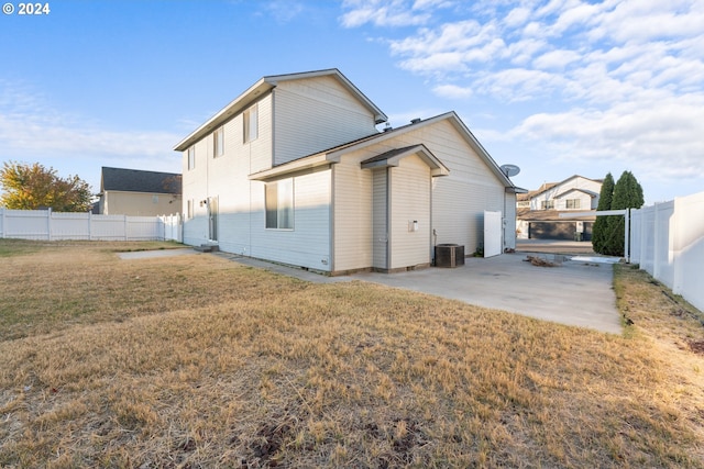 rear view of house featuring a yard, a patio, and cooling unit