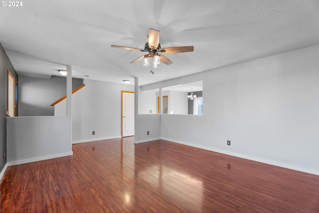 unfurnished room featuring ceiling fan with notable chandelier, wood-type flooring, and a textured ceiling