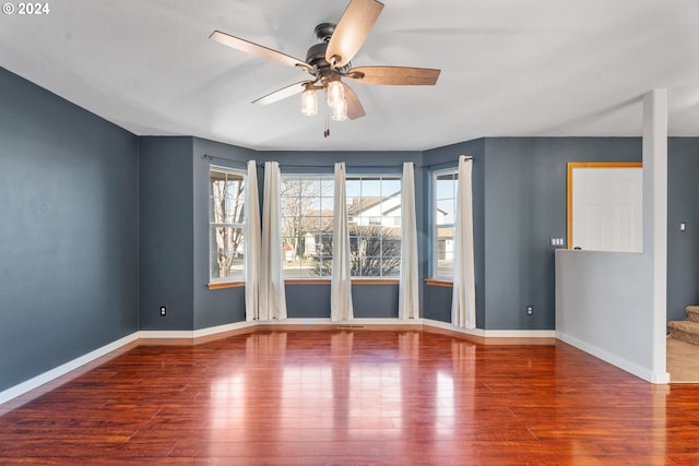 spare room featuring hardwood / wood-style floors and ceiling fan