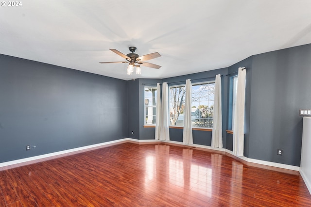 empty room with ceiling fan and wood-type flooring