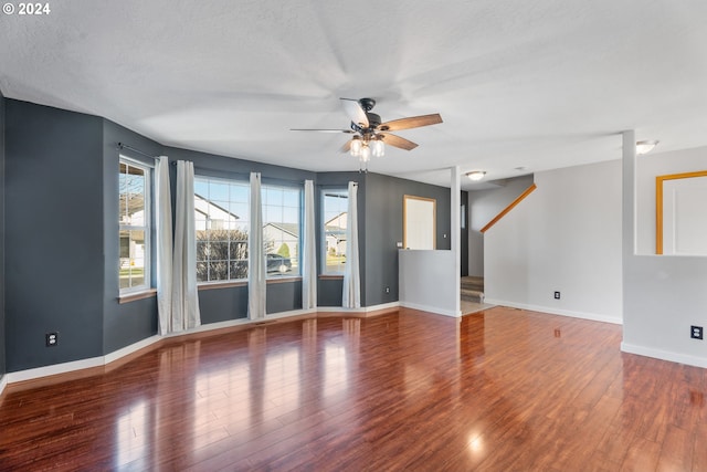 empty room featuring ceiling fan, a textured ceiling, and hardwood / wood-style flooring