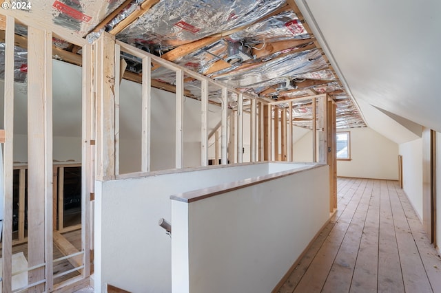 interior space featuring hardwood / wood-style floors and vaulted ceiling