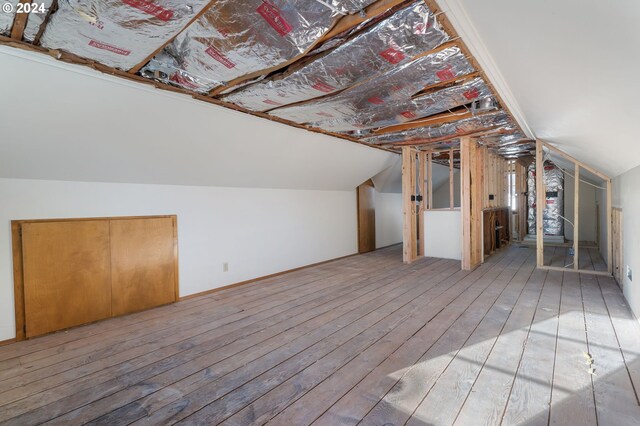 bonus room featuring lofted ceiling and hardwood / wood-style flooring