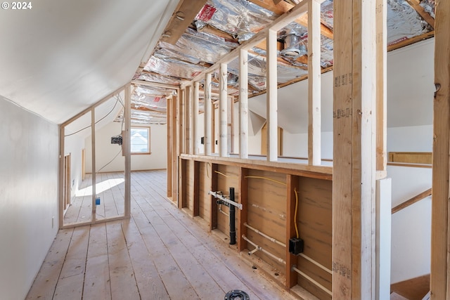 interior space featuring wood-type flooring and lofted ceiling