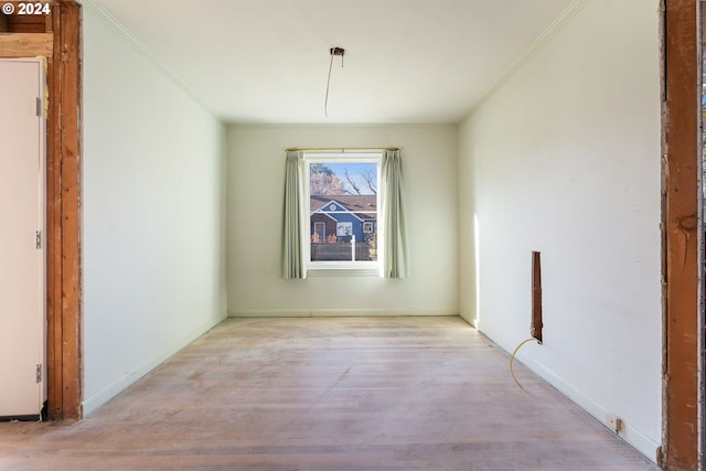 unfurnished dining area featuring light hardwood / wood-style floors and ornamental molding