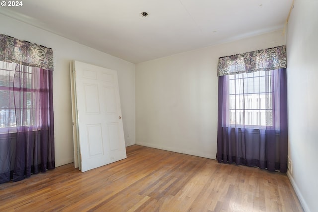 empty room with hardwood / wood-style flooring